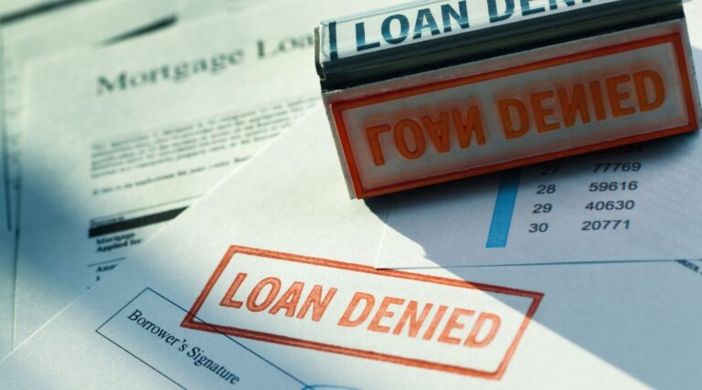 red rubber stamp denying mortgage lending application documents